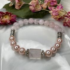 Feminine Energy 🖤 It's soothing colors will help bring you more peace of mind 😌 Made with Love & Light: - Rose Quartz Focal - Rose Quartz - Tibetan Silver Accents - Silver Tone Accents - Faux Pink Pearls - Fits up to 8" wrist ----- My favorite meditation bead mantra: "Om Mani Padme Hum" (ohm-mah-nee-pahd-may-huum) This is a simple yet effective mantra to use during your meditation with our beads. "Om Mani Padme Hum" is a commonly used mantra. This manta has been known to connect with the bless Adjustable Rose Quartz Spiritual Stretch Bracelet, Spiritual Hand-strung Rose Quartz Stretch Bracelet, Hand-strung Spiritual Rose Quartz Stretch Bracelet, Adjustable Rose Quartz Stretch Bracelet, Spiritual Style, Adjustable Rose Quartz Stretch Bracelet Gift, Rose Quartz 8mm Bead Stretch Bracelet As A Gift, Pink Round Beads Stretch Bracelet For Meditation, Pink Adjustable Beaded Bracelets For Healing, Spiritual Pink Crystal Bracelet As Gift