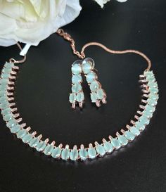 Chic Rosegold Diamond Necklace Set featuring mint green moonstones and high-quality CZ stones. This Bollywood-inspired cocktail jewelry set is perfect for Indian and Pakistani weddings or special events. The matching earrings are 1.2 inches long and lightweight at just 0.2 oz for added comfort and style. Our products are meticulously handcrafted, ensuring each piece is unique. Due to the manual craftsmanship, you may notice slight irregularities, which are natural and do not compromise the quality of the jewelry. Jewelry Pakistani, Cocktail Jewelry, Diamond Necklace Set, Bollywood Jewelry, Jewelry Indian, Pakistani Wedding, Diamond Set, Bead Embroidery, Rose Gold Diamonds