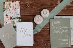 the wedding stationery is laid out on a wooden table with two photos and ribbons