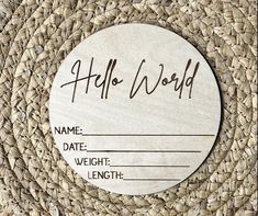 a round wooden plaque with the words hello world on it and an image of a rattan background