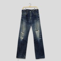 "Size 33x35 Vintage Levi's 702 LVC Redline Selvedge Jeans Faded Ripped Denim 90s Levi's Big E Japan Buckle Back Levi's Distressed Denim W33 Please contact me for any questions about this clothing before buying. SIZE MEASUREMENTS :- WAIST : 33\" inches HIPS : 44\" inches THIGH: 26\" inches  LEG OPENING : 17\" inches RISE : 12\" inches INSEAM : 35\" inches OUTSEAM (TOTAL LENGTH) : 46\" inches WEIGHT : 0.81 kg Condition : Distressed faded dirty jeans Good Vintage Conditions. Please pay close attent Retro Distressed Jeans For Streetwear, Vintage Jeans Medium Wash With Frayed Hem, Vintage Jeans With Medium Wash And Frayed Hem, Vintage Medium Wash Jeans With Frayed Hem, Vintage Denim Jeans With Frayed Hem, 90s Style Distressed Dark Wash Jeans, 90s Style Distressed Denim Blue Jeans, 90s Distressed Denim Blue Jeans, 90s Distressed Dark Wash Jeans