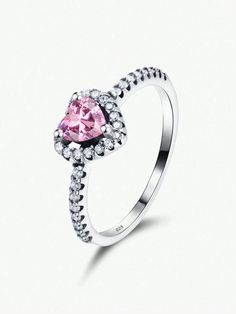 a pink heart shaped ring with diamonds around it