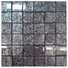 a black and white tile wall with squares in the middle, all over it's surface