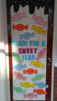 a door decorated with candy for a sweet year and words written on the front doors