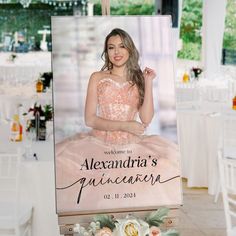 a woman in a pink dress is standing next to a sign that says welcome to alexandria's quinceauera