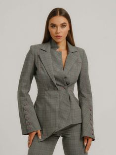 The details in this plaid check blazer will blow you away. It is bold, sharply tailored and definitely leaves a lasting impression. It is fully lined and features padded shoulders, funnel sleeves with large sets of covered buttons and an asymmetric hemline.  The deconstructed cut with double lapels on one side creates the illusion of a triple breasted blazer. The richness of the design is enhanced by placing the fabric panels under different angles.  Style it with its matching Get Down to Business Wide-Leg Trousers to complete the power suit. Hand wash only. Wash inside out with like colors. Do not wring or twist. Do not tumble dry. Iron at 160°C max or use press cloth. Do not bleach. Professional dry clean. Asymmetric Blazer, Check Blazer, Blazer Jackets For Women, Power Suit, Checked Blazer, Tailored Blazer, Gifts For New Mums, Independent Designers Fashion, Jacket Sale