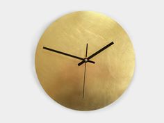 a gold clock with black hands on a white background