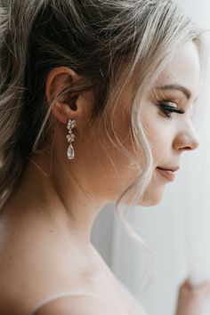 a woman with blonde hair wearing earrings