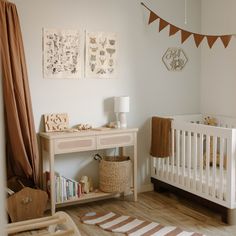 a baby's room with a white crib and wooden furniture