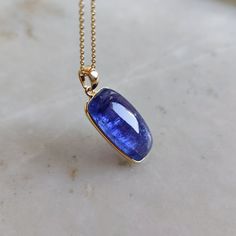 This stunning pendant is set in 14k Solid Yellow Gold with Natural Tanzanite with utmost precision. It is an unique gemstone pendant for nearly every occasion and is completely hassle-free jewelry. ITEM DETAILS: * GEM: Tanzanite * GEM SIZE: 10X20mm * GEM SHAPE: Rectangle * Gem WEIGHT: 15.76 carats * Gold Purity: 14KT * Gold Weight: 0.61 gram * Total Weight: 3.76 gram The Gold purity is guaranteed and it comes with authentic 14KT gold hallmark. Since my items are handmade, they are absolutely nickel and lead free. CUSTOMIZATION: * Gemstone customization is available and it can be substituted with a gem of your choice. Kindly message me for the same. PACKAGING * The Pendant comes with layers of safe and secure wrapping along with Free handmade jewelry box with every purchase. ➡️Head to these Fine Jewelry Rectangular Tanzanite, Rectangular Tanzanite Jewelry For Anniversary, Classic Rectangular Tanzanite Jewelry, Sapphire Gemstone Jewelry With Rectangular Pendant, Gemstone Oblong Necklace For Gift, Oblong Gemstone Necklace For Gift, Tanzanite Pendant, Capricorn Sign, Handmade Jewelry Box