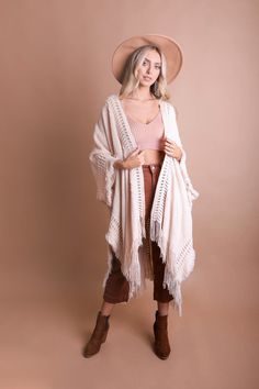 Looking for a stylish and fun way to stay warm this winter? Check out our Open Work Frayed Bohemian Ruana! This cute and cozy wrap is perfect for chilly days and nights, and can be dressed up or down to suit any occasion! #lovemyleto 100% Acrylic Imported Bohemian Shawl For Fall Layering, Cozy Fall Poncho For Beach, Beige Bohemian Shawl Poncho, Oversized Bohemian Outerwear With Fringe, Bohemian Fringe Outerwear For Fall, Bohemian Fall Outerwear With Tassels, Chic One-size Shawl For Spring, Chic One Size Shawl For Spring, One Size Cozy Outerwear For Festivals