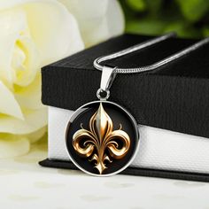 "🌘MESSAGE CARD🌒 Let the presence of the Fleur de Lis transport you to an era of grandeur and opulence, where craftsmanship and artistic expression flourished, and where the spirit of nobility still resonates today. 🌘JEWELLERY DESCRIPTION🌒 Embrace the elegance of French Royalty with our stunning Fleur de Lis graphic pendants. Our Fleur de Lis jewelry masterfully captures the regal charm and timeless sophistication of this iconic symbol. Each piece is intricately crafted from surgical steel, f Elegant Commemorative Medallion Jewelry, Elegant Round Pendant Necklace For Commemoration, Elegant Engraved Jewelry For Commemorations, Elegant Engraved Jewelry For Commemoration, Elegant White Gold Necklace For Commemoration, Elegant Sterling Silver Necklace For Commemoration, Elegant Silver Jewelry For Commemoration, Vintage Necklace With Polished Finish For Gift, French Royalty