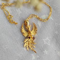 Phoenix Fire Bird Sterling Silver Necklace with Real Citrine and Garnet with 22k gold plated. Phoenix (/ˈfiːnɪks/; Ancient Greek: φοῖνιξ, phoînix) is a mystical bird associated with fire and sun, it obtains new life by arising from the ashes of its predecessor. Original design from sketch of Phoenix Pendant with citrine faceted teardrop and garnet faceted round. Material: full sterling silver 925. pendant size: 4x2cm Chain length: 40cm Please bear in mind that photo may slightly different from a Phoenix Fire Bird, Phoenix Fire, Phoenix Pendant, Fire Bird, Book Jewelry, Fancy Jewelry, Disney Outfits, 22k Gold, Sterling Silver Necklace