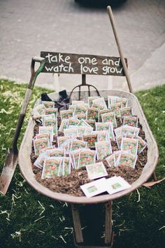 a wheelbarrow filled with lots of cards sitting on top of a grass covered field