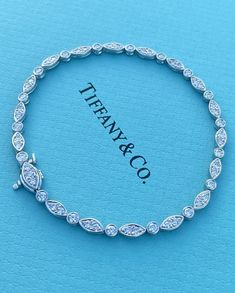 Tiffany & Co Jazz Diamond and Platinum Tennis Bracelet Tiffany & Co. Jazz Collection 55 round brilliant cut diamonds, total weight 1.60ct Marquise Set Diamond G color VS1 clarity Bracelet measures 3.3mm wide Bracelet measures 7'' long Clasp stamped "T&CO PT950" Bracelet is in excellent condition - Gift-able Comes with original external and internal Tiffany box Includes a copy of Tiffany letter of authenticity and description Guaranteed Authentic SPECIAL NOTES: Photos have been enlarged to provide best details. Condition Rating is subjective and we have accessed this item to the best of our ability. Collectible - Will make a perfect gift or a great addition to a jewelry collection. If per chance we had overlooked any critical detail, hopefully our photos will be useful, so please preview al Tiffany & Co Jewelry, Tennis Bracelet Diamond Tiffany, Tennis Bracelet Tiffany, Tiffany And Co Bracelet, Tiffany And Co Jewelry, Tiffany Box, Set Bracelet, Bracelet Box, Wide Bracelet