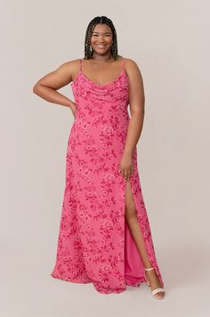 a woman in a pink dress posing for the camera