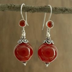 Believed to mirror the sun's energy carnelian the birthstone of July glows with fiery beauty in earrings by Narayani. Sterling silver settings reflect Indian elegance in earrings that are crafted by hand in India. .925 Sterling silver Agate Drop Earrings, Agate Gemstone Earrings Gift, Agate Gemstone Earrings For Gifts, Orange Jewelry Gift, Nickel-free Carnelian Jewelry, Bohemian Round Agate Earrings, Orange Fusion Jewelry Gift, Carnelian Drop Earrings Jewelry Gift, Fusion Style Earrings With Natural Stones For Gift