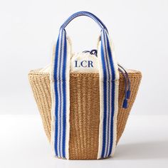 a blue and white striped tote bag on a white background with the letter i c r printed on it