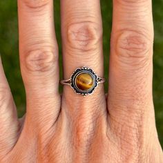 Beautiful handmade tigers eye ring, made with sterling silver 925.  It's has a dainty band with a flower border.  Size 8.5 ▵SHOP DETAILS▵ ▵ Complimentary gift box(jewelry) ready to gift!  ▪️All jewelry is cleaned & polished before sent out. ▪️I hand make, photograph, model and package/ship every item.  ▪️ALL PIECES ARE ONE OF A KIND, I DO NOT ALTER SIZES. Please read shop for more details. ▪️Handling time: 1-4 business days, depending on volume of orders. Handling time is not the same as shippin Tigers Eye Ring, Tiger Eye Ring, Dainty Band, Tourmaline Stone, Flower Border, Eye Ring, Box Jewelry, Tigers Eye, Red Coral