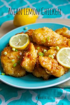 chicken wings with lemons and scallions on a blue plate