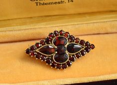 A beautiful antique gold filled Bohemian garnet brooch.   Measures: 3.3 cm x 1.9 cm (1.3" x 0.7") Weight 3.8 grams Excellent vintage condition The box on the photos for display only! Will be delivered by tracked and signed mail. Thank you for looking. Please see my other items. Antique Gold Brooch With Gemstone, Antique Gold Gemstone Brooch, Antique Yellow Gold Brooches With Gemstone, Antique Jewelry With Screw Back For Gift, Antique Screw Back Jewelry For Gift, Antique Gold Brooch For Gift, Ornate Antique Gold Brooch For Gift, Antique Red Brooch For Formal Occasions, Antique Gold Brooches As Gift