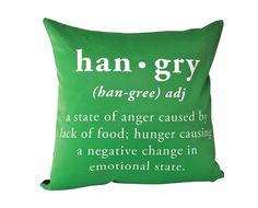 a green pillow with the words han - gry written in white ink on it