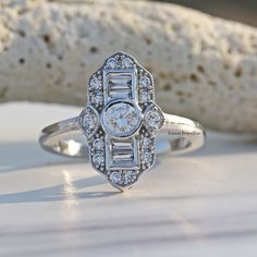 Victorian Retro Edwardian Ring/ Round Moissanite Engagement Ring/ Baguette Bezel Set Ring/ Antique Art Deco Style Ring In 14K White Gold 𝐃𝐞𝐬𝐜𝐫𝐢𝐩𝐭𝐢𝐨𝐧 𝐨𝐟 𝐑𝐢𝐧𝐠 👉 All Stone Material:- Moissanite/Lab Diamond 👉 All Stone Shape:- Round Cut/ Baguette Cut 👉 All Stone Color:- Colorless 👉 All Stone Clarity:- VVS 👉 Stone Luster:- Excellent 👉 Stone Make:- High Quality ● 𝐌𝐞𝐭𝐚𝐥 𝐃𝐞𝐭𝐚𝐢𝐥𝐬 👉 Metal Type:- 𝟗𝟐𝟓 𝐒𝐢𝐥𝐯𝐞𝐫 / 𝟗𝟑𝟓 𝐀𝐫𝐠𝐞𝐧𝐭𝐢𝐮𝐦 𝐬𝐢𝐥𝐯𝐞𝐫/ 𝟏𝟎𝐊𝐓/𝟏𝟒 Engagement Ring Baguette, Baguette Engagement Ring, Round Moissanite Engagement Ring, Ring Baguette, Edwardian Ring, Bezel Set Ring, Stone Material, Ring Antique, Eco Friendly Jewelry