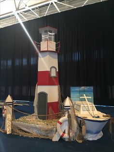 there is a boat and a lighthouse on display