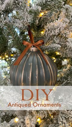 an ornament hanging from the top of a christmas tree with text overlay that reads diy antique ornaments