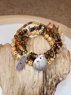 "These triple stackable bracelets are for any of my fellow dreamers!🌠 . These bracelets are made with a variety of colored beads, wooden beads, and tiger's eye gemstones. . There are two charms contained in this set. One says \"Miracle\" and one says \" Wishes do come true\". . Tigers eye is referred to as the stone if courage. I chose to tie all of this together to create this beautiful set because it takes a lot of courage to put your trust in faith. To dream, to wish, to pray?? Those are all things that give us hope and when we remain positive and believe in miracles we show an immense amount of courage and strength.  . I loved making this set and I hope the person who ends up owning it never loses faith and always keeps their eyes towards the sky." Hand-strung Hippie Style Wrap Bracelet As Gift, Hippie Hand-strung Wrap Bracelet As Gift, Multicolor Bohemian Stacked Bracelets, Bohemian Multicolor Stacked Bracelets, Bohemian Stacked Bracelet Jewelry, Bohemian Nickel-free Friendship Bracelets As Gift, Bohemian Nickel-free Wrap Bracelet As Gift, Bohemian Stacked Round Bead Bracelets, Bohemian Stackable Wrap Bracelet As Gift