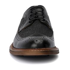 The irresistible Garret shoe by Vintage Foundry Co. exceeds expectations for a classic pair of oxfords. With its delicate design and dual-tone construction, this lace-up style stands out and demands a second look. Perfectly blending timeless elegance with a modern twist, the Garret shoe elevates any outfit, whether formal or smart-casual. Its distinctive look and superior craftsmanship ensure you make a memorable impression, combining sophistication with a bold, eye-catching design. Wingtip Oxford Lace-up Shoes With Textured Sole, Black Brogue Lace-up Dress Shoes, Black Wingtip Lace-up Shoes With Textured Sole, Textured Sole Wingtip Oxfords, Black Wingtip Lace-up Shoes For Formal Occasions, Black Lace-up Dress Shoes For Derby, Black Business Oxfords With Textured Sole, Black Oxfords With Textured Sole, Black Plain Toe Oxfords With Textured Sole