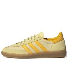 a yellow adidas sneakers on a white background