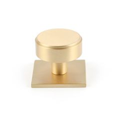 a brass knob on a white background