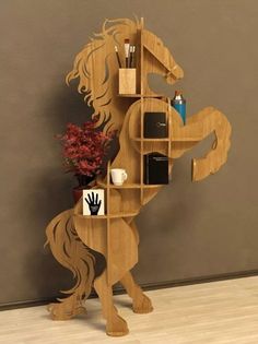 a wooden horse shaped shelf with various items on it