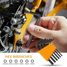 hex wrenches are being used to fix a motorcycle