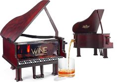 a wine bottle being poured into a glass next to a piano