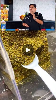 a man standing in front of a counter with food on it and a giant spoon