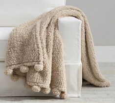 a white couch with a blanket on top of it