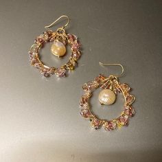 Beautiful and delicate Pearl and gold earrings. Gemstones and glass seed beads wrapped in gold-plated wire. Peach/pink pearl and pink tourmaline create a beautiful combination. Lilac seed beads along with various small seed beads create a unique combination 14K Gold filled earwires, hypoallergenic and safe for delicate skin Comes in box and can be gifted. Handmade Pink Pearl Earrings, Handmade Pink Round Pearl Earrings, Delicate Gold Wire Wrapped Hoop Earrings, Bohemian Pink Wire Wrapped Beaded Earrings, Pink Wire Wrapped Beaded Earrings With Round Beads, Pink Wire Wrapped Beaded Earrings, Pink Wire Wrapped Hoop Earrings, Pink Wire Wrapped Round Hoop Earrings, Gold-filled Wire Wrapped Beaded Earrings