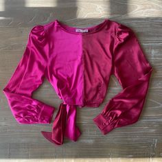 Bought From A Local Boutique In Baton Rouge, La Called “Dawson Street”. New With Tags! Never Worn Before!! Bought For $48.00 Asking For $25.00 Or Best Offer. The Top Is A Vibrant Satin Blouse By The Boutique Brand "Lalavon." It Features A Color-Block Design In Two Shades Of Pink: A Bright Fuchsia On The Left And A Slightly Deeper Magenta On The Right. The Blouse Has Long Sleeves With A Slight Puff At The Shoulders And Buttoned Cuffs, Adding A Touch Of Elegance To The Overall Look. It Also Includ Pink Fitted Top For Brunch, Fitted Pink Tops For Brunch, Pink Cropped Top For Work, Long Sleeve Pink Satin Top, Pink Satin Feminine Blouse, Luxury Pink Satin Blouse, Pink Color Block V-neck Top, Pink Silk Button-up Blouse, Pink Long Sleeve Blouse