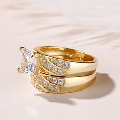 two gold rings with diamonds on them