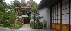 an entrance to a house with wood trimmings on the door and side walk