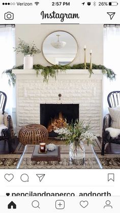 a living room filled with furniture and a fire place covered in greenery next to a fireplace