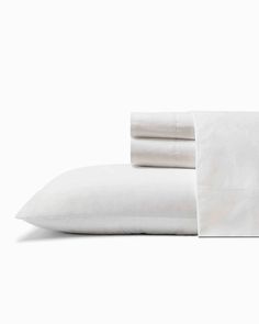 white sheets and pillowcases on a white background