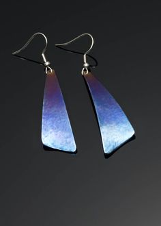 Straight handmade titanium earrings in the shape of an irregular, elongated triangle, 44 mm long. They owe their beautiful colours to a special technique - anodized. Choose your colour blue, gold violet, light violet, violet. Earring hooks (ear wires) are made from surgical steel. As a metal, Titanium is nearly indestructible and antiallergic. It does not bend or become deformed, and any nicks or scratches it incurs through daily wear can easily be buffed out for it to appear new and flawless once again. These beautiful earrings will be perfectly matched with evening dresses. Earrings come with a beautiful gift box. When a product is unavailable, lead time about 3 weeks. Our earrings are handmade and all photos are for illustration purpose only. The colours of the earrings may slightly dif Blue Triangle Earrings For Gift, Modern Blue Long Drop Earrings, Anodized Titanium, Light Violet, Titanium Earrings, Beautiful Colours, Earring Hooks, Beautiful Gift Boxes, Lead Time