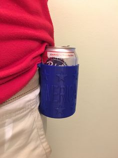 a person wearing a red shirt is holding a blue can