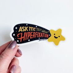 a person holding up a sticker that says ask me about what hyperexation