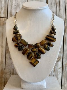 Tiger Eye is mesmerizing with its shimmering bands of yellow-brown to golden color -21 inch necklace with 2 1/2 inch drop -.925 overlay sterling silver -adjustable length with toggle closure   Originally $258. On limited time SALE Elegant Brown Necklace With Polished Finish, Luxury Adjustable Necklace With Natural Stones, Formal Adjustable Necklace With Stones, Unique Brown Gemstone Jewelry, Luxury Handmade Brown Necklaces, Adjustable Brown Costume Jewelry, Brown Adjustable Costume Jewelry, Luxury Handmade Brown Necklace, Unique Brown Jewelry With Stones