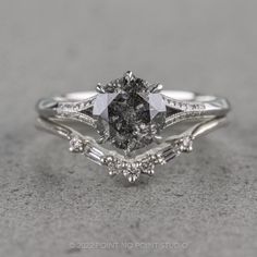 a white gold engagement ring set with an oval cut diamond and baguettes on the side