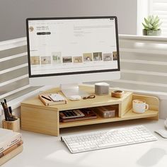 a computer monitor sitting on top of a desk next to a keyboard and mouse pad